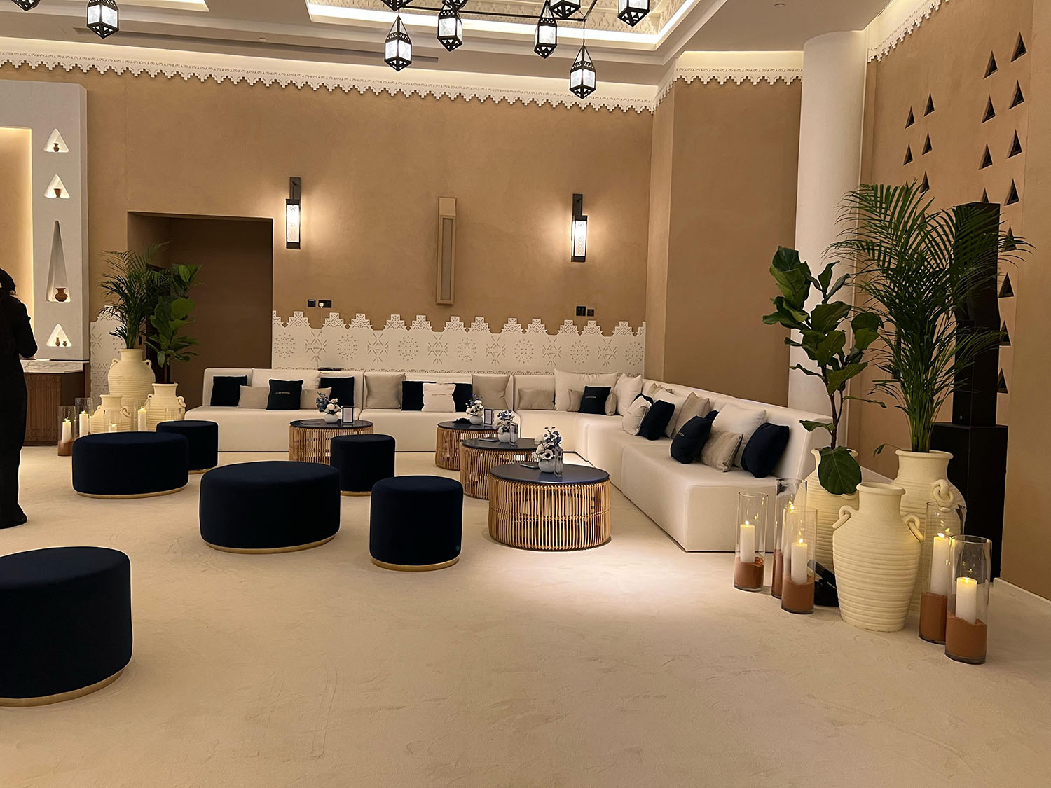 Modern majlis lounge featuring modular sofas and natural wood coffee tables