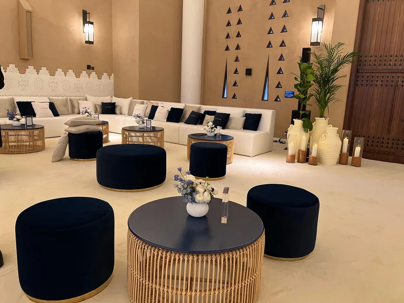 Velvet poufs and layered décor creating a welcoming majlis environment.